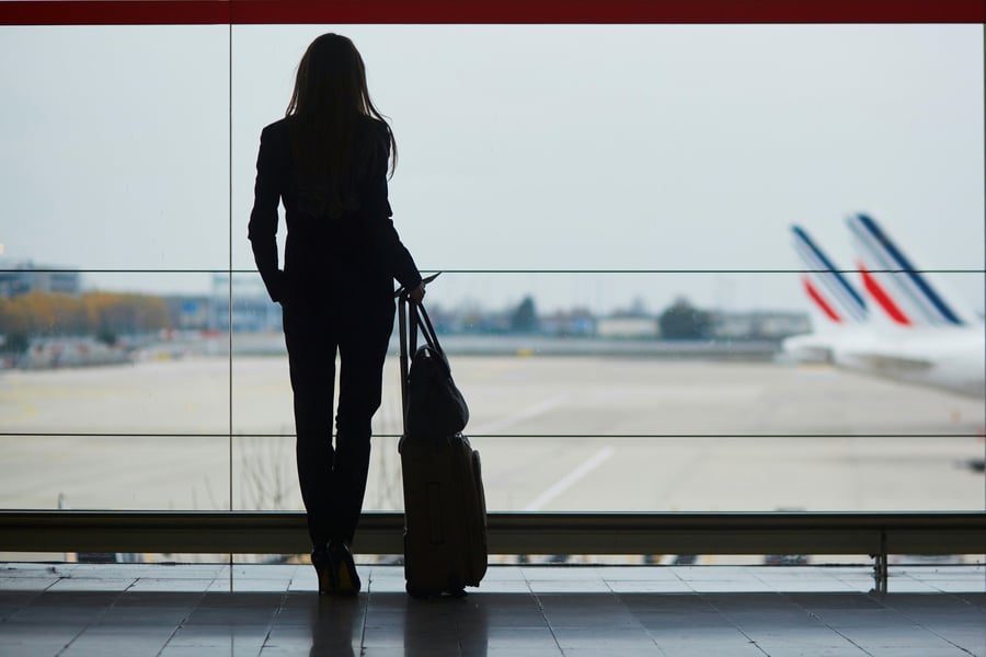 woman traveling for business standing in the airport